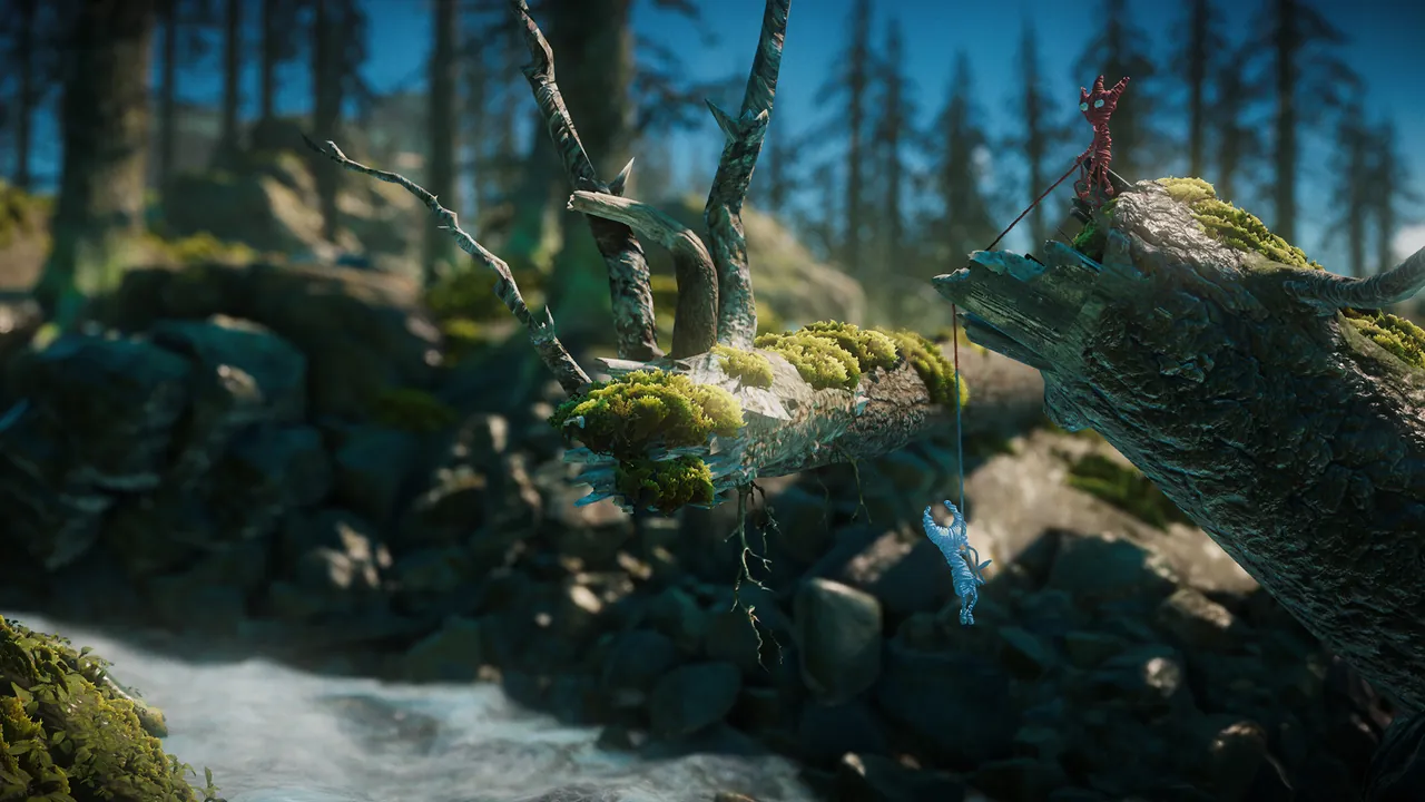 Two Yarnys tied together by one thread: a red Yarny holds on to a mossy fallen tree while a blue Yarny dangles below it above a forest stream.